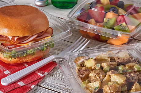 32 oz tamper evident hinged deli container with various kind of deli food